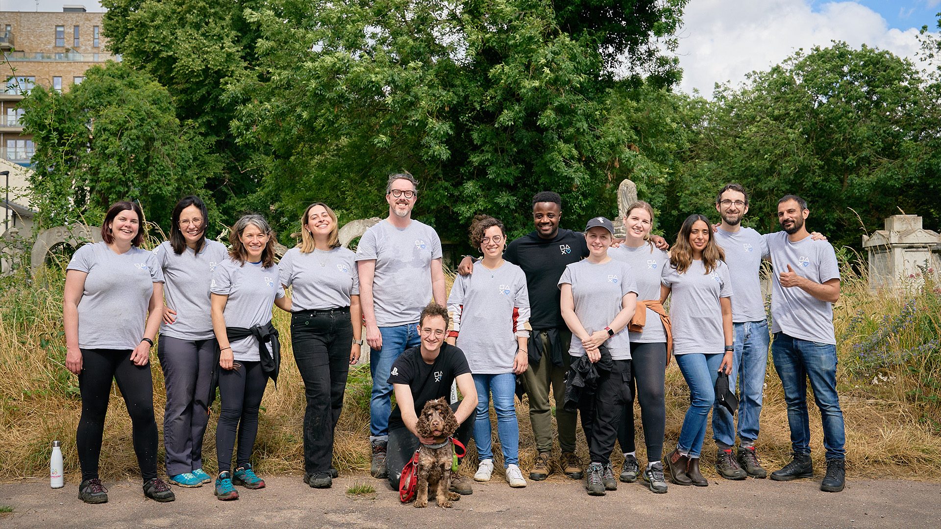 An outdoor group photo of employees and a dog that participated in projects at the Vinters Valley Nature Reserve, a volunteer-run space dedicated to preserving and enjoying nature.