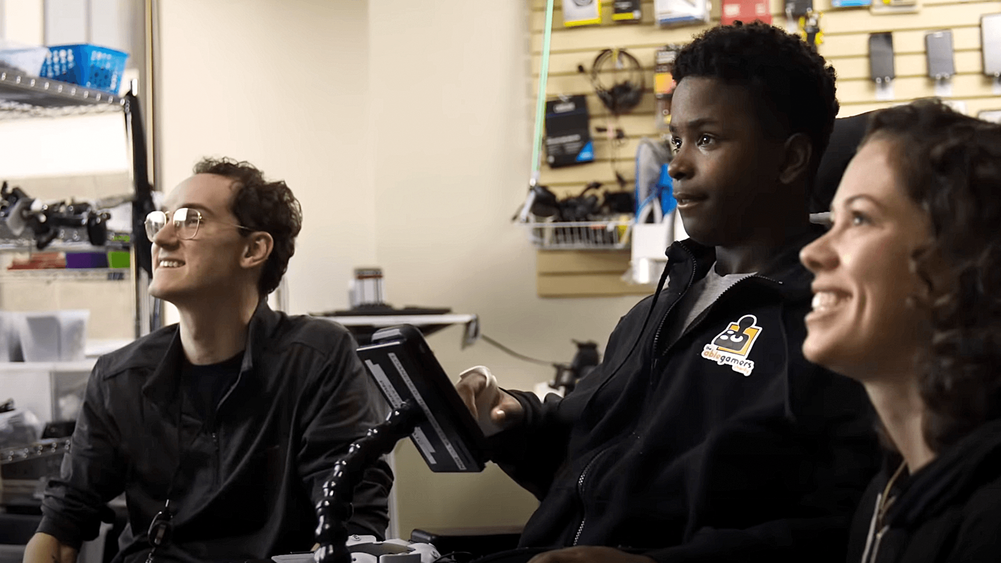 Disabled player playing games next to Sony Interactive employees.