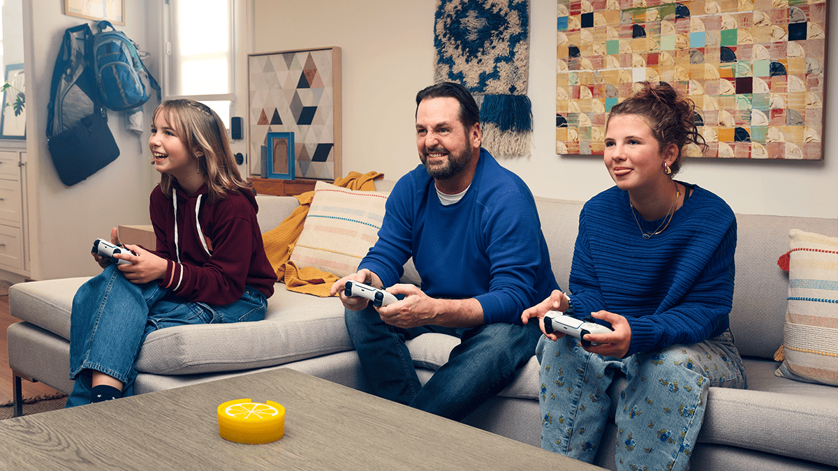 A family playing games on their couch in a living room setting