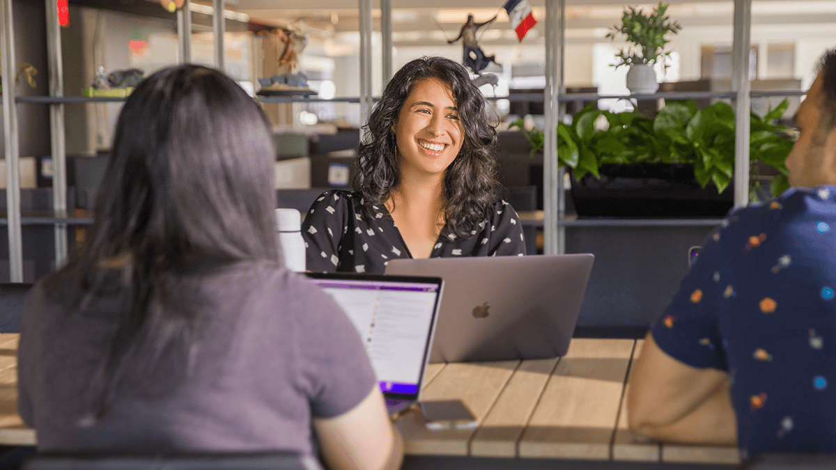Sony Interactive employees in a meeting on their laptops in an office setting
